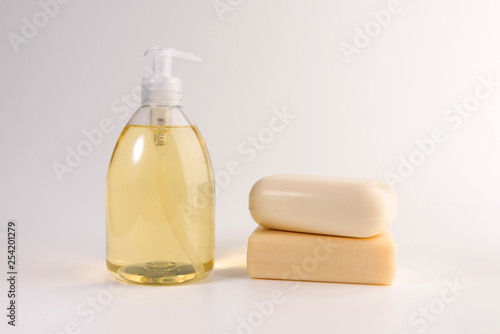 liquid soap and two pieces of solid soap isolated on  white background