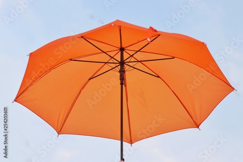 Orange umbrellas floating on the air, isolate on the background, sunset sky.