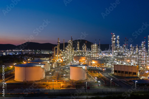 Aerial view. Oil refinery factory and oil storage tank at twilight and night. Petrochemical Industrial.