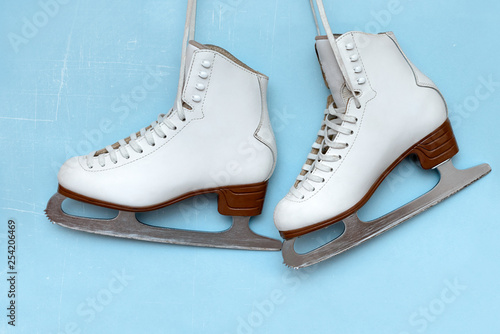 Vintage ice skates for figure skating hanging on the backg