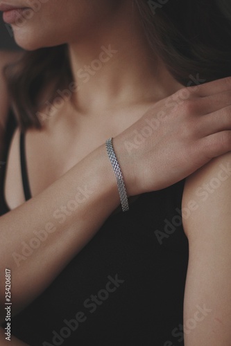 bracelet of silver and gold on the hand of a beautiful girl