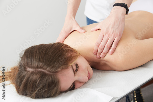 Female Enjoying Relaxing Massage In Cosmetology Spa Center