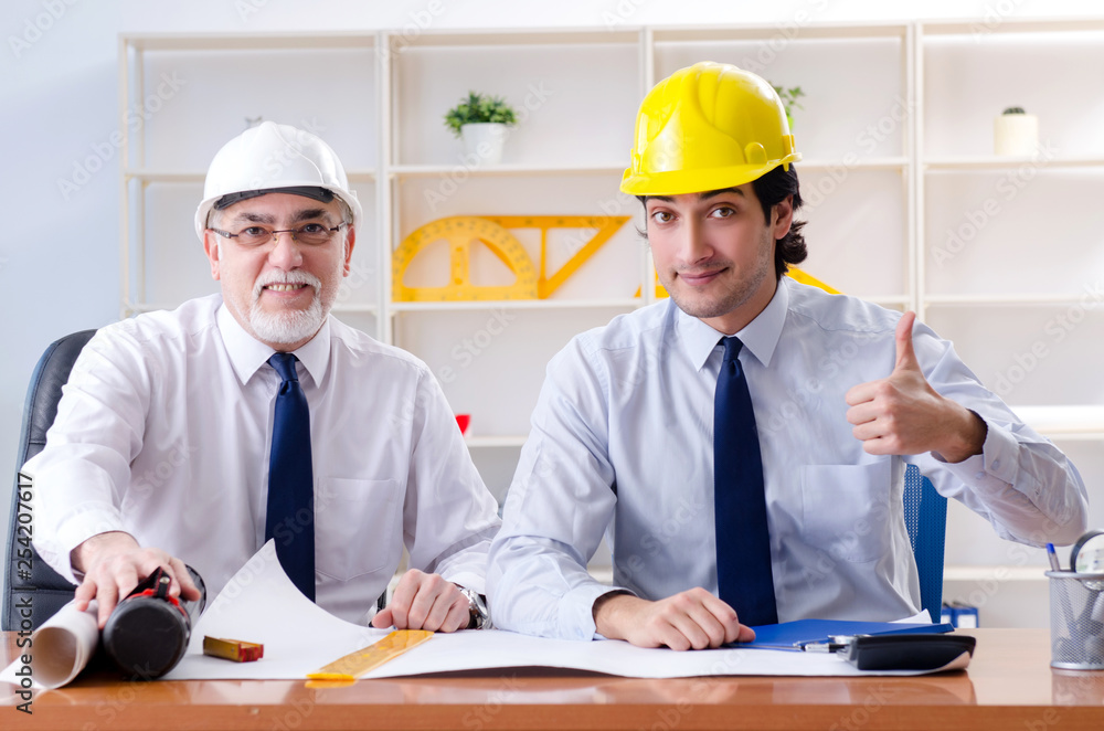 Two engineers colleagues working under project Two engineers colleagues working under project