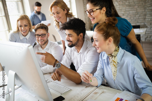 Group of business professionals having a meeting. Diverse group of designers smiling at the office.