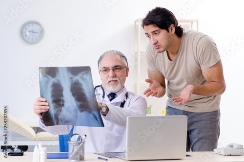 Young man visiting old male doctor radiologist 