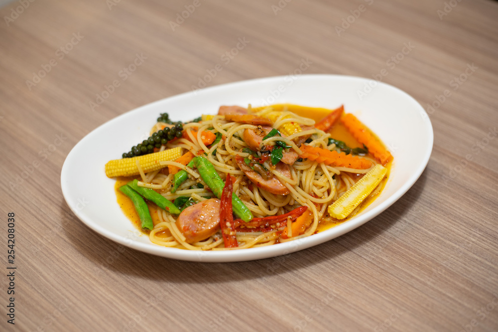 spaghetti with sausage in white plate- Italian food spaghetti with sausage in white plate- Italian food