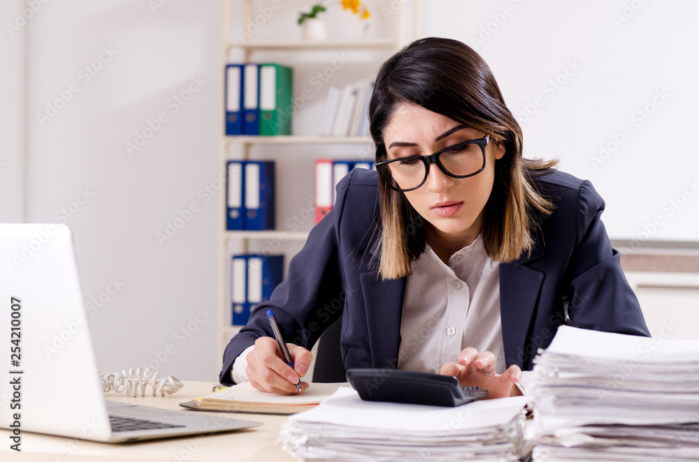 Young female employee working in the office Young female employee working in the office
