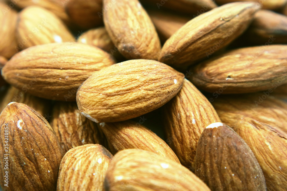 Fototapeta premium Almonds peeled macrophotography as background for design.