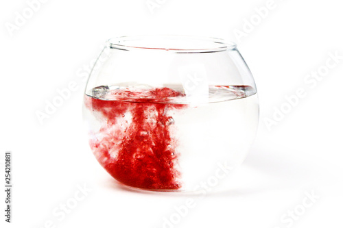 19. The red liquid poured in the glass utensil, in transparent liquid. The mixing of different color liquids. The concept of medical theme on the isolated white background.
