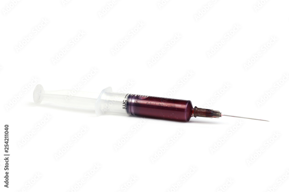 5 ml syringe with red liquid lies on the white background. The concept of blood sucking. 5 ml syringe with red liquid lies on the white background. The concept of blood sucking.