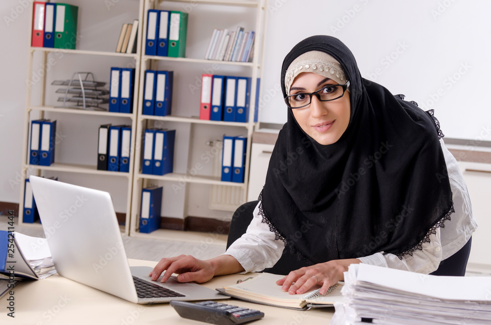 Female employee in hijab working in the office Female employee in hijab working in the office