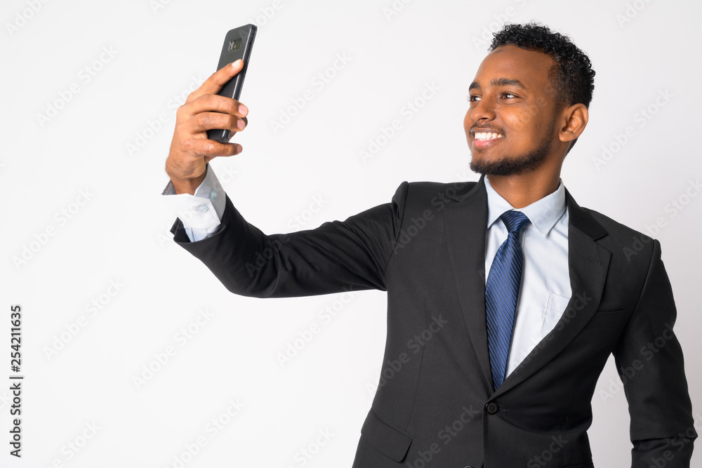 Happy young handsome African businessman taking selfie Happy young handsome African businessman taking selfie