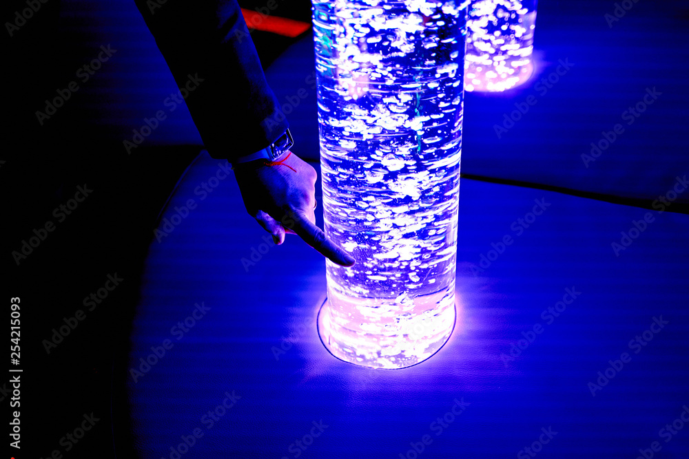 custom made wallpaper toronto digitaltherapy sensory stimulating multi sensory room, woman interacting with colored lights bubble tube lamp during therapy session