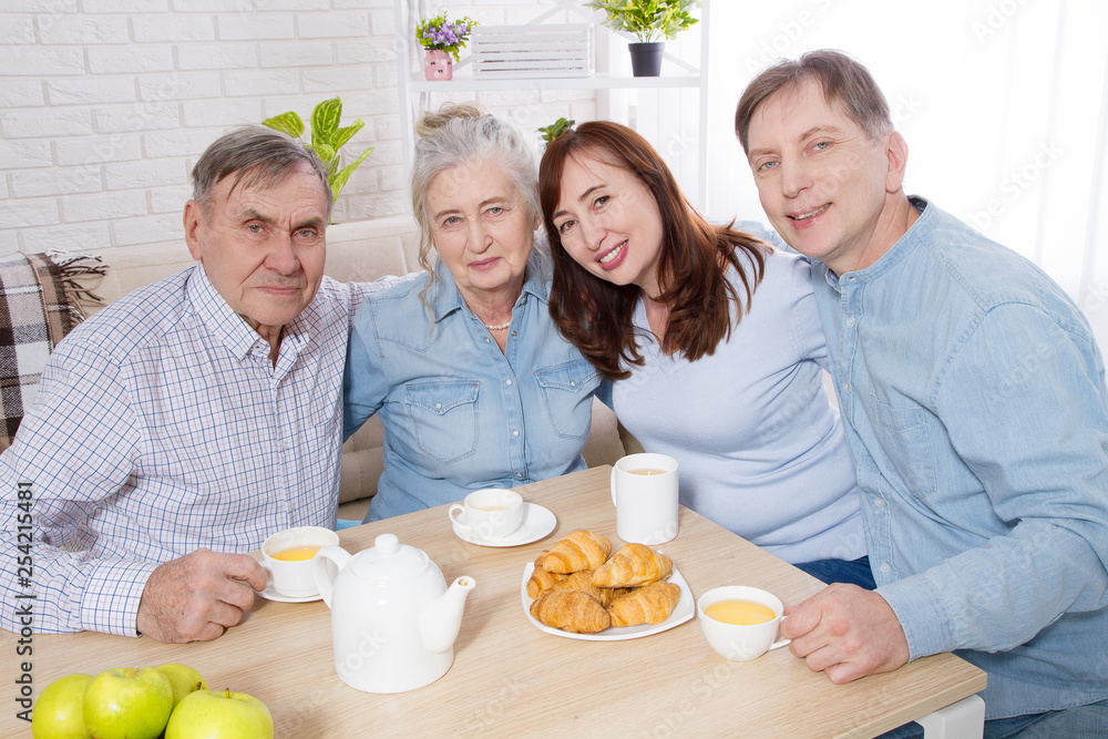 Happy family tea time at nursing home for elderly. Parents with children have fun talk communication and leisure. Senior couple and relatives. Visit old mother and father. Parenting care concept Happy family tea time at nursing home for elderly. Parents with children have fun talk communication and leisure. Senior couple and relatives. Visit old mother and father. Parenting care concept