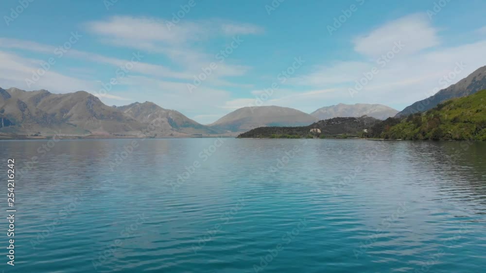 Flying over Lake Wakatipu, Queenstown, New Zealand with mountain in background - Aerial Flying over Lake Wakatipu, Queenstown, New Zealand with mountain in background - Aerial