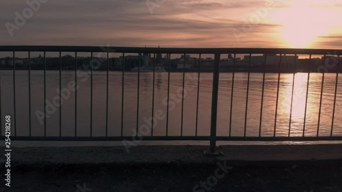 Rhine river aerial view during sunset. Drone is flyinf behind a railing photo