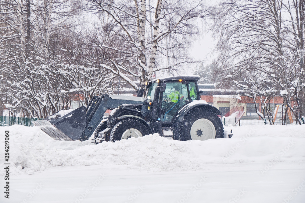 Tractor clearing street after a snow storm Tractor clearing street after a snow storm