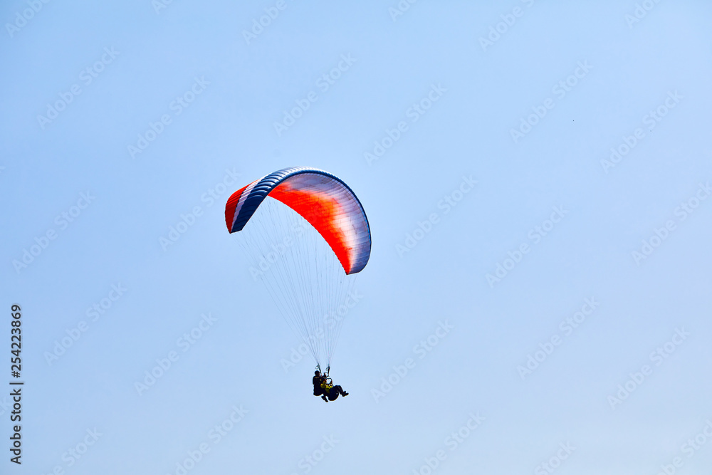 Flying on a paraglider. Beautiful view with mountains and colorful paragliders. Extreme vacation travel Flying on a paraglider. Beautiful view with mountains and colorful paragliders. Extreme vacation travel