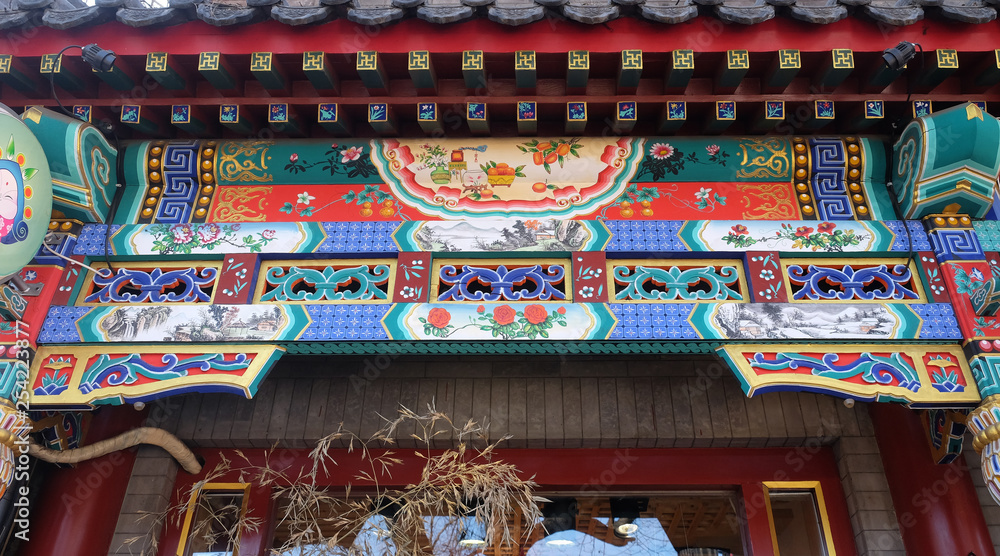 An ornate painted ceiling on a building in the Forbidden City in Beijing, China