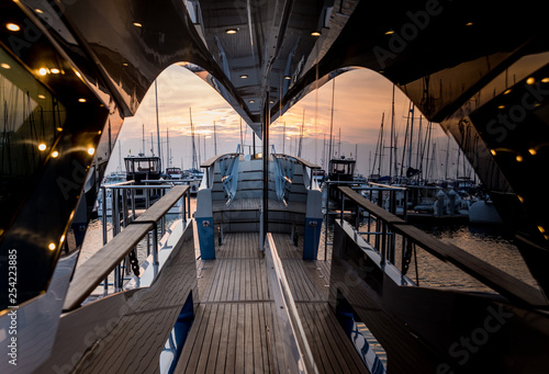 View of harbor with yachts details. Beautiful sunset sky in the marina bay.
