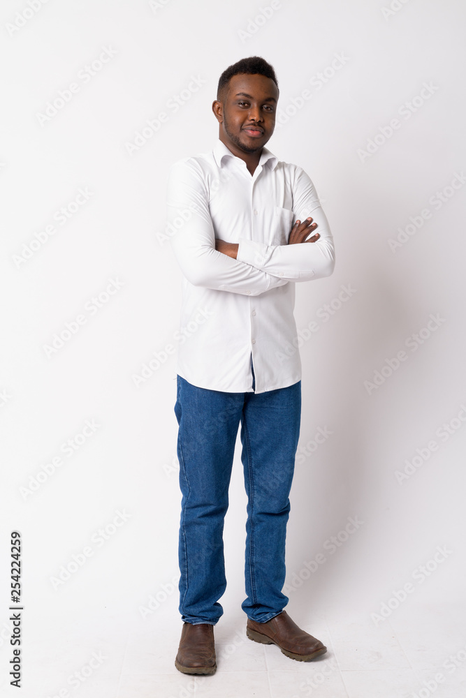 Full body shot of young African businessman with arms crossed Full body shot of young African businessman with arms crossed