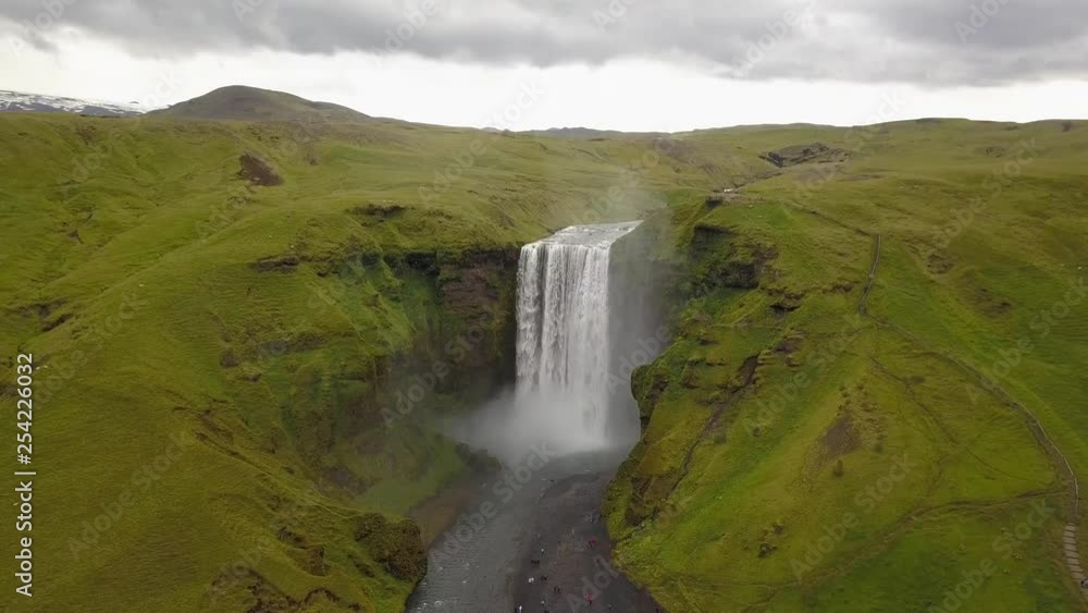 Ascending aerial view of the Skogafoss waterfall in Iceland, stunning scenery in the back. Ascending aerial view of the Skogafoss waterfall in Iceland, stunning scenery in the back.