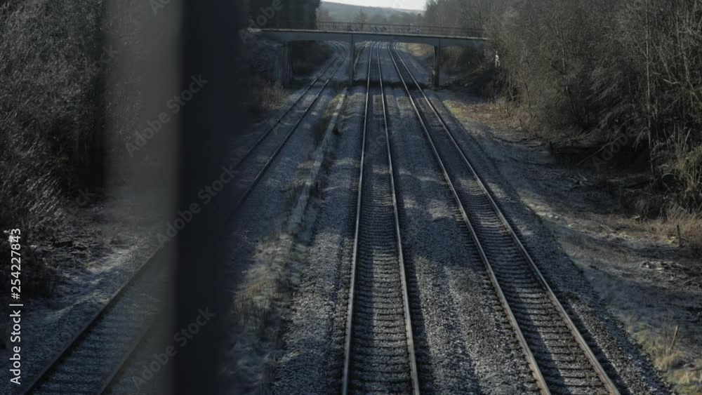 View overlooking three train tracks view through a bridge structure View overlooking three train tracks view through a bridge structure