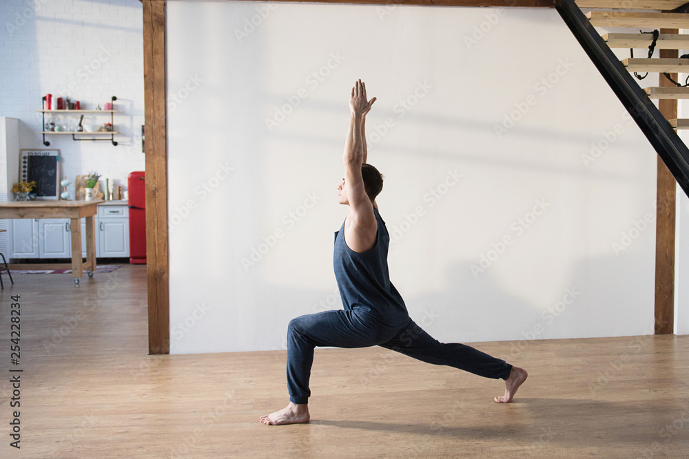 Young man doing yoga indoor. Workout Exercise Fitness Health Concept. Young man doing yoga indoor. Workout Exercise Fitness Health Concept.
