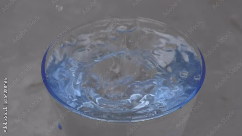 close up of a water drop in a glass close up of a water drop in a glass