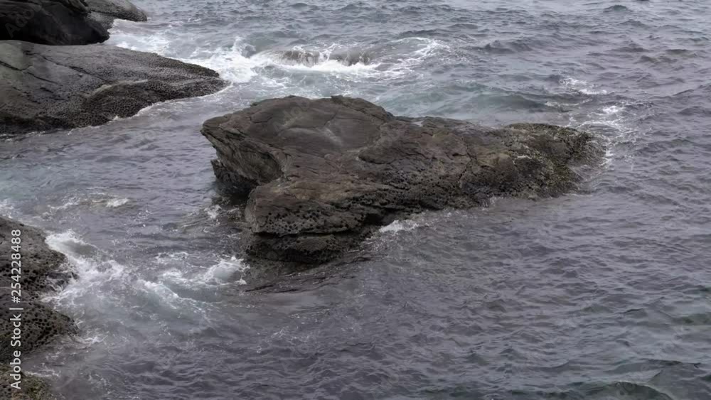 Sea shore and stones. Seascape  with gushing waves on the coast