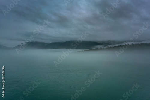 Clouds and mist over the forest and water in Prince Williams © David