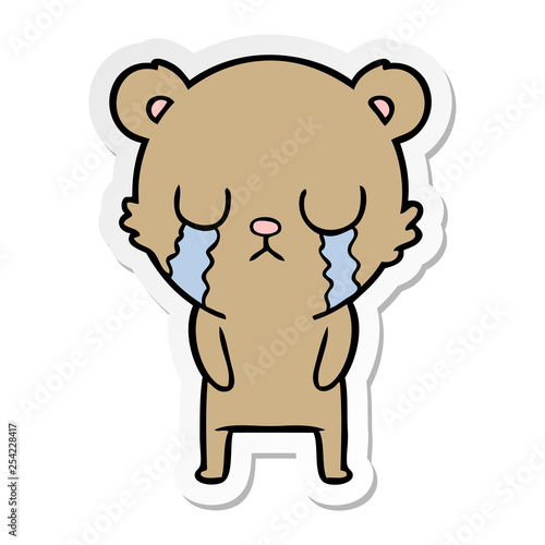 distressed sticker of a cartoon bear crying