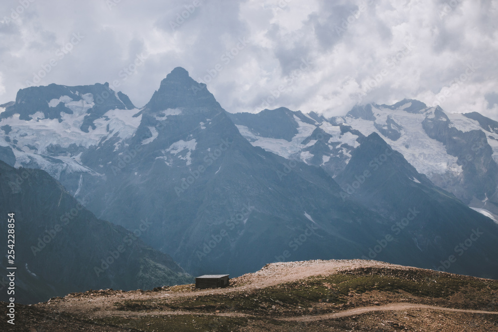 Panorama of mountains scene with dramatic blue sky in national park of Dombay