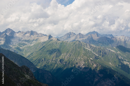 Panorama of mountains scene with dramatic cloudy sky in national park of Dombay © TravelFlow