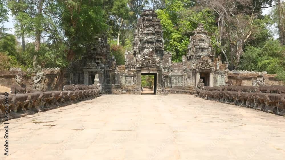 Approaching monumental gates of ruins in Angkor Wat Cambodia