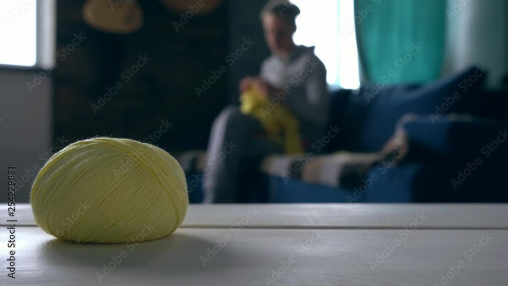 Woman sitting on the sofa and engaging in a hobby at home, she is ...
