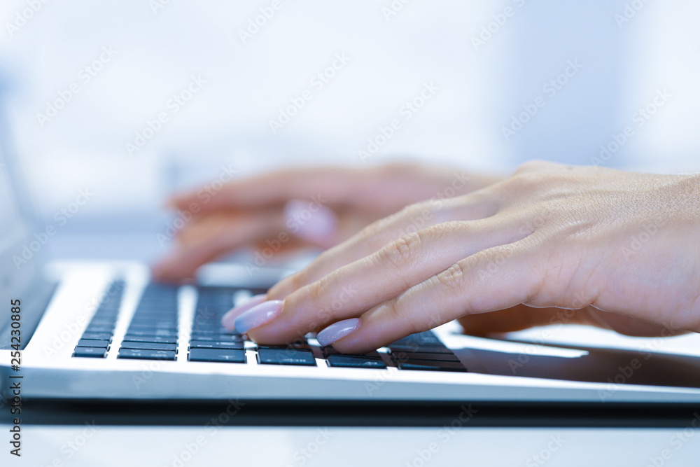 Closeup of businesswoman typing on laptop computer Closeup of businesswoman typing on laptop computer