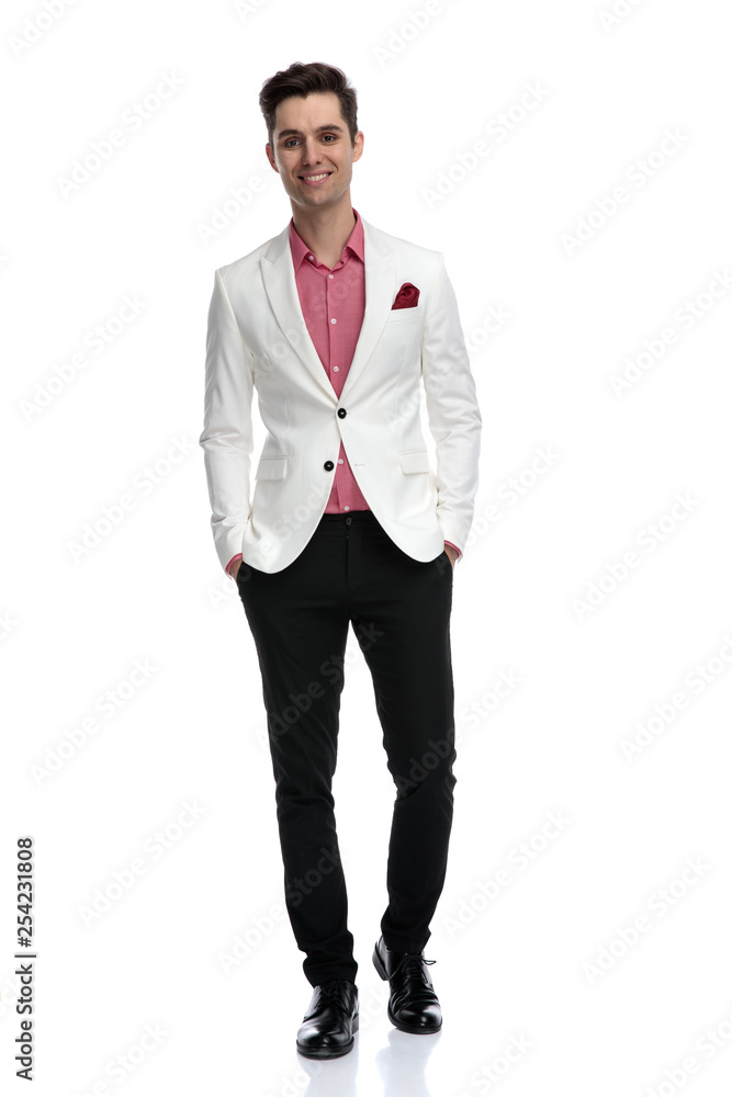young successful young man standing with hands in pockets young successful young man standing with hands in pockets