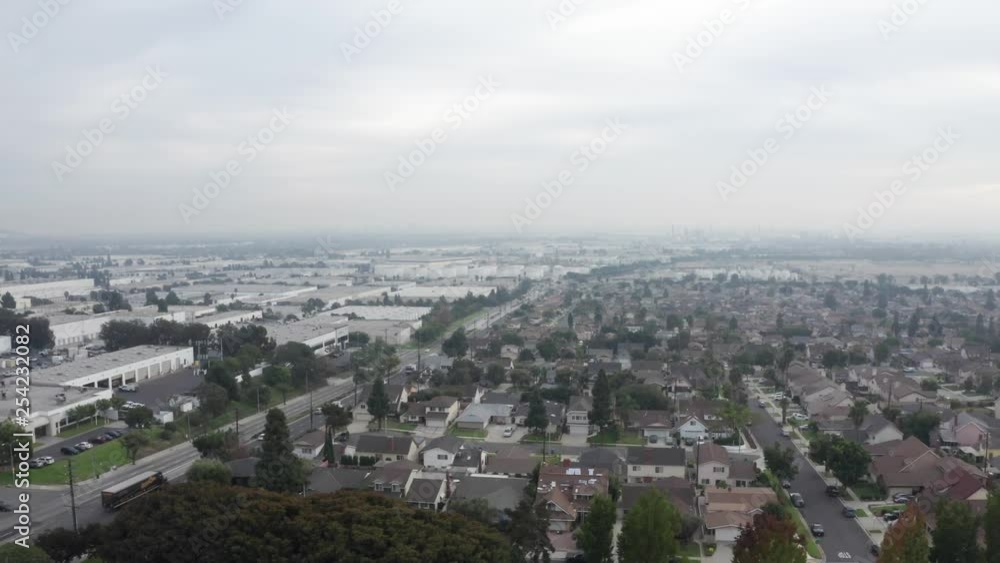 Aerial Drone flying backward over City of Carson, California, foggy day Aerial Drone flying backward over City of Carson, California, foggy day