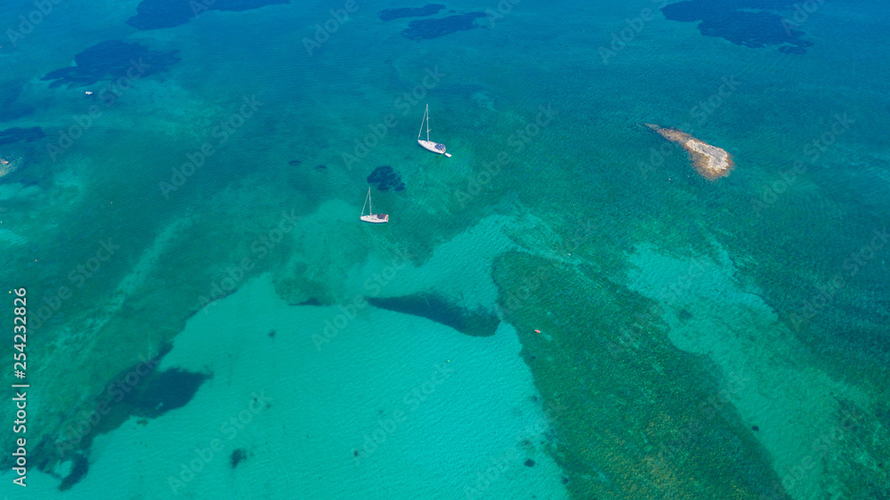 Fototapeta premium Colonia Sant Jordi, Mallorca Spain. Amazing drone aerial landscape of the charming Estanys beach and the boats with a turquoise caribbean sea