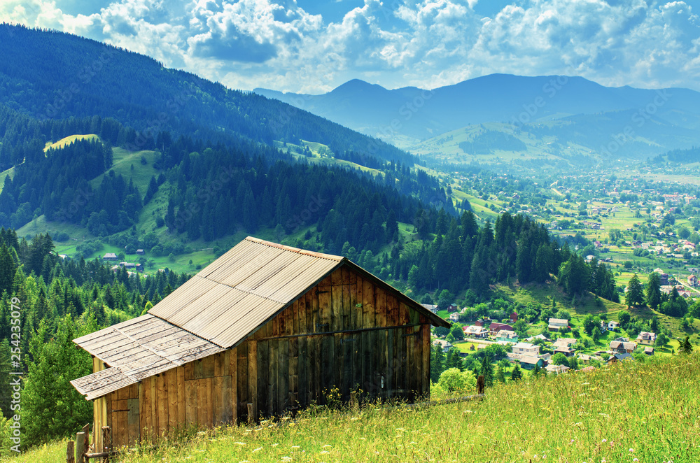 wooden house on a slope in the mountains far from the village wooden house on a slope in the mountains far from the village