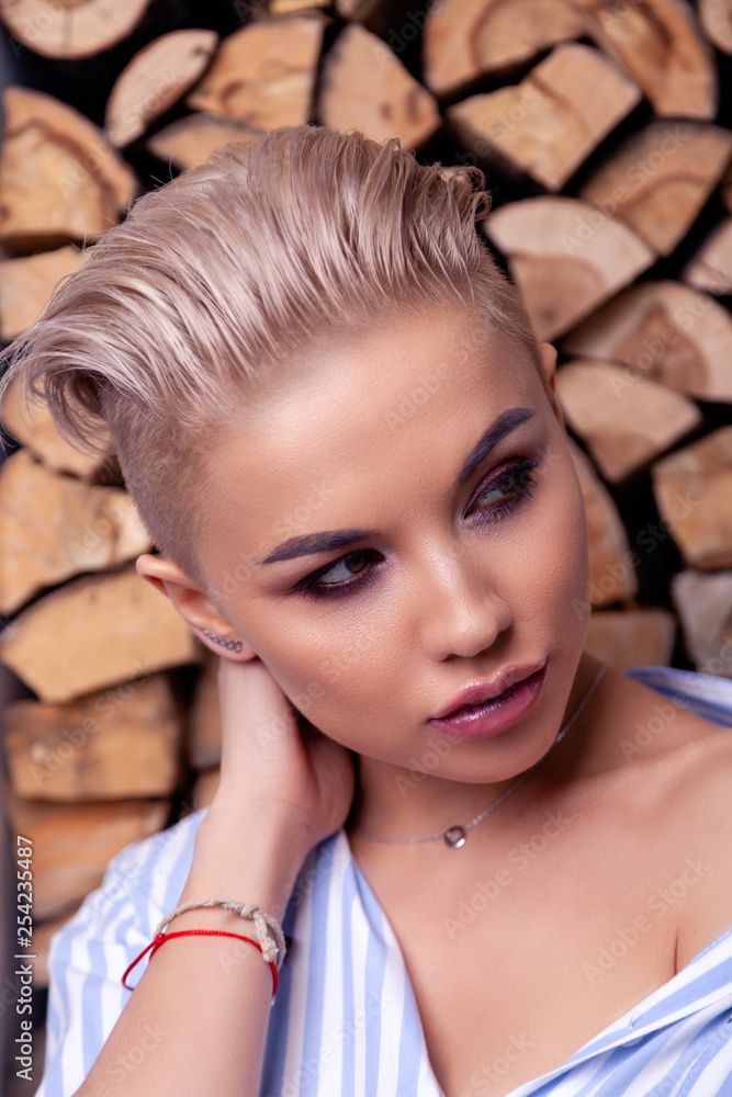 Closeup portrait sexy blonde model with bright make-up and short hair with  shaved temples in a modern silver jewelry, earrings, rings, bracelet,  necklace. Сoncept fashion shooting Stock Photo | Adobe Stock