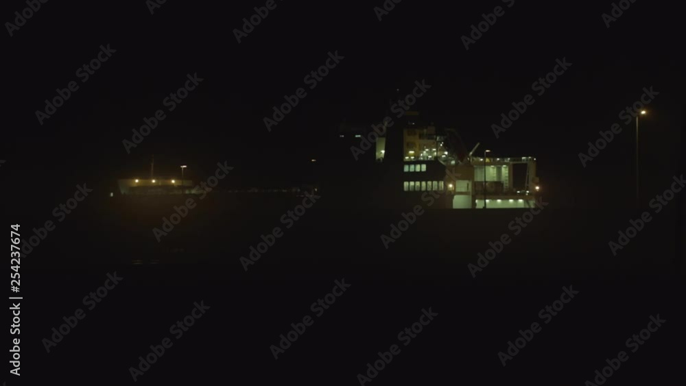 Wide shot of a cargo ship in Matosinhos (Porto, Portugal) at night, parked by the docks Wide shot of a cargo ship in Matosinhos (Porto, Portugal) at night, parked by the docks