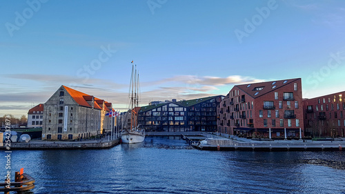 Nyhavn waterfront, canal and entertainment district with colorful houses, buildings, ships, yachts and boats in Old Town of Copenhagen, Denmark