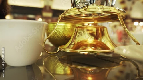 Close look at the old Arabian classic pot for arabic coffee made from gold photo
