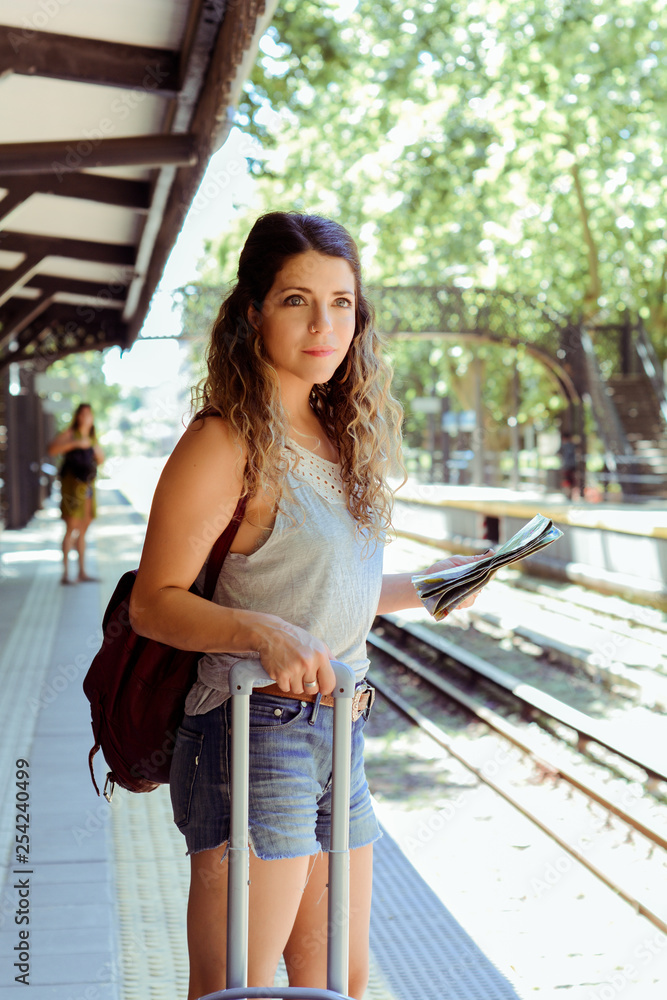 Woman with suitcase waiting the train. Woman with suitcase waiting the train.