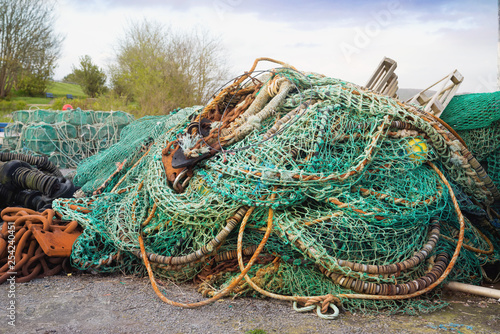 Fishing nets, ropes and rusty chains in a Castletownbere harbor photo