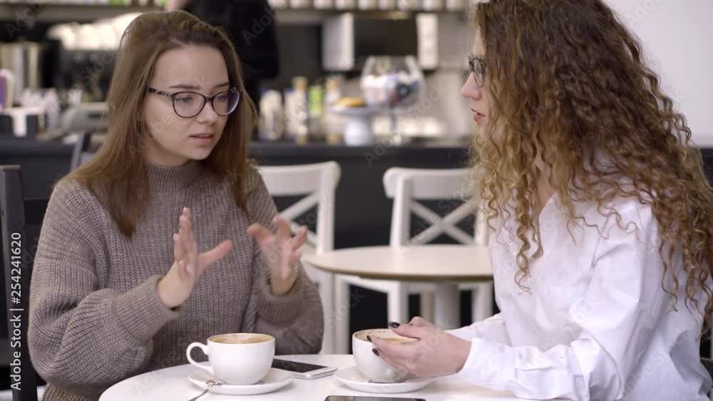 Best girls talking to each other in cafe. Best girls talking to each other in cafe.