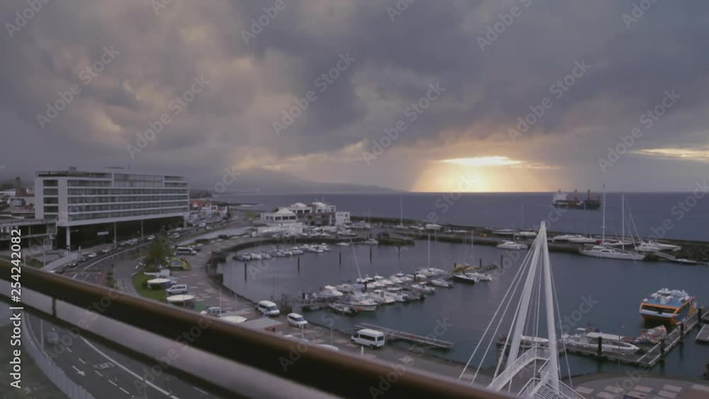 Sunrise view at the sea port and marina of Ponta Delgada on the island of Sao Miguel of the Portuguese Azores. Tracking shot from a balcony. Sunrise view at the sea port and marina of Ponta Delgada on the island of Sao Miguel of the Portuguese Azores. Tracking shot from a balcony.
