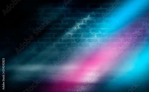 Empty scene background. Empty brick wall  concrete floor  spotlight  multicolored neon rays  bokeh.